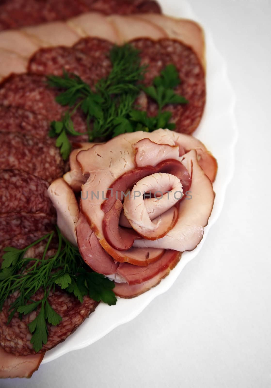 The cut sausage on a white plate