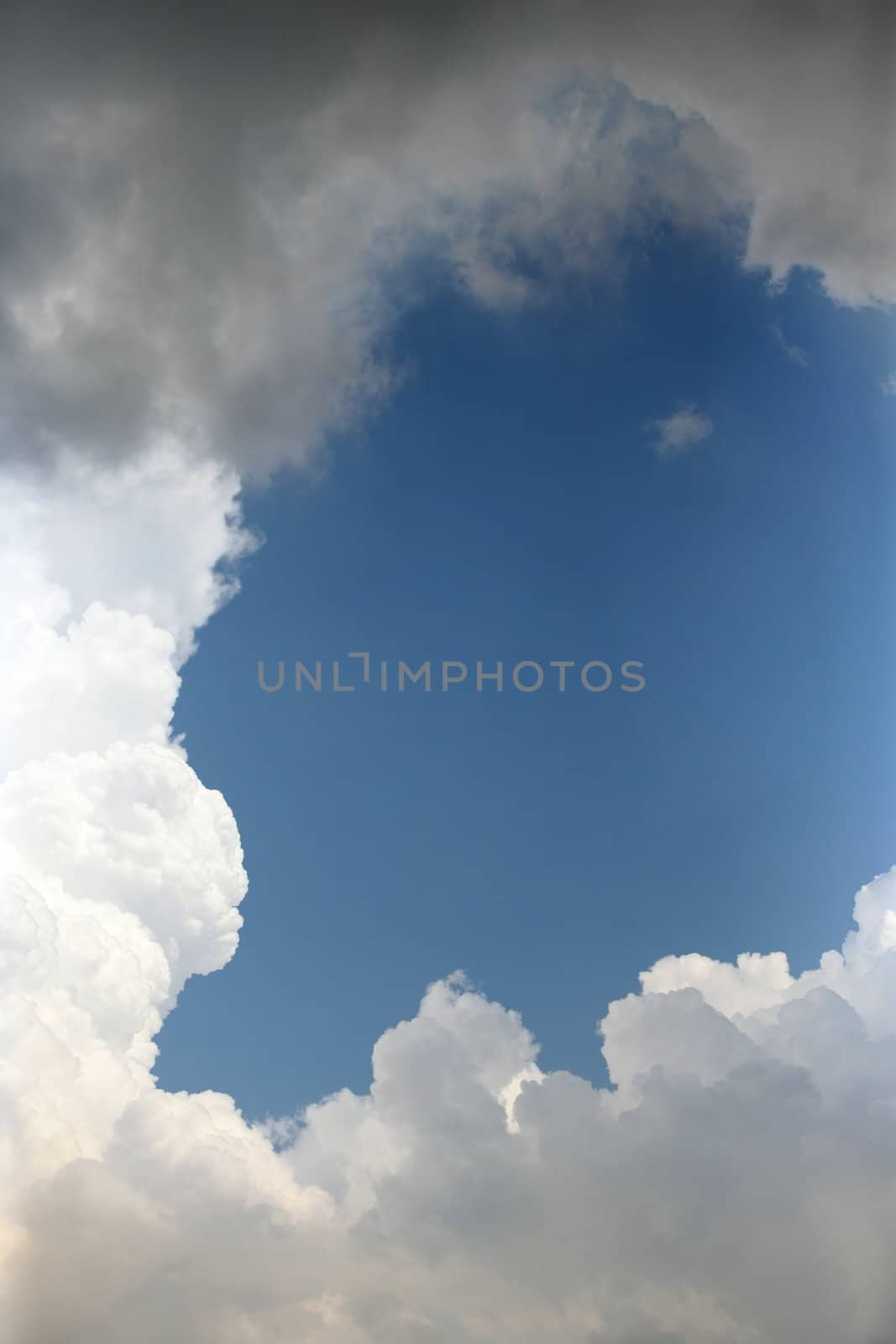 The image of white clouds on a background of the dark blue sky