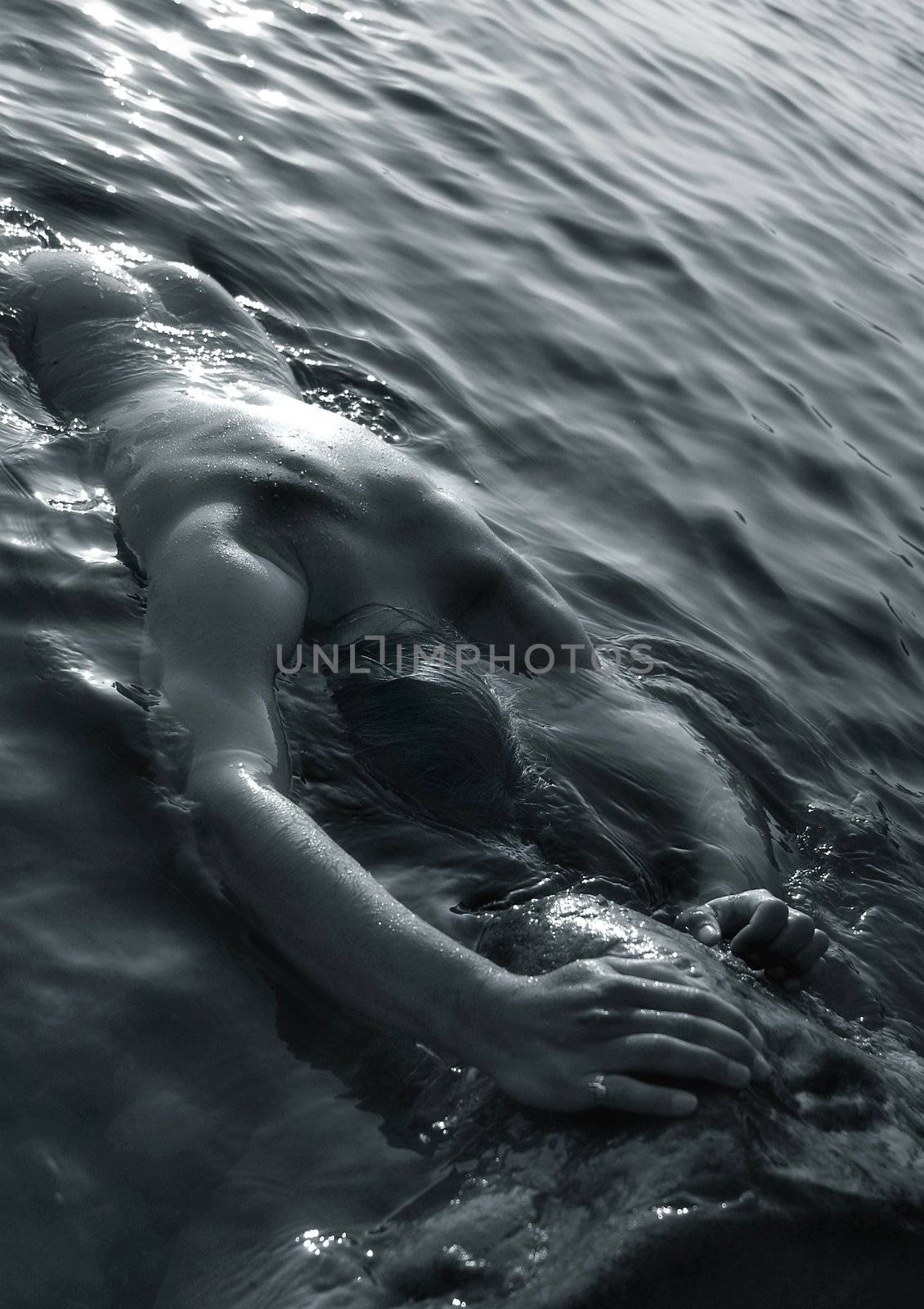 The man with a beautiful body in water