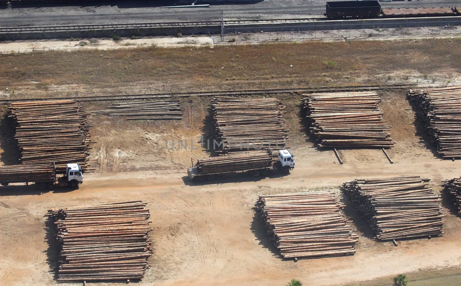 Aerial view of a Lumber Yard with trucks transporting the timber.