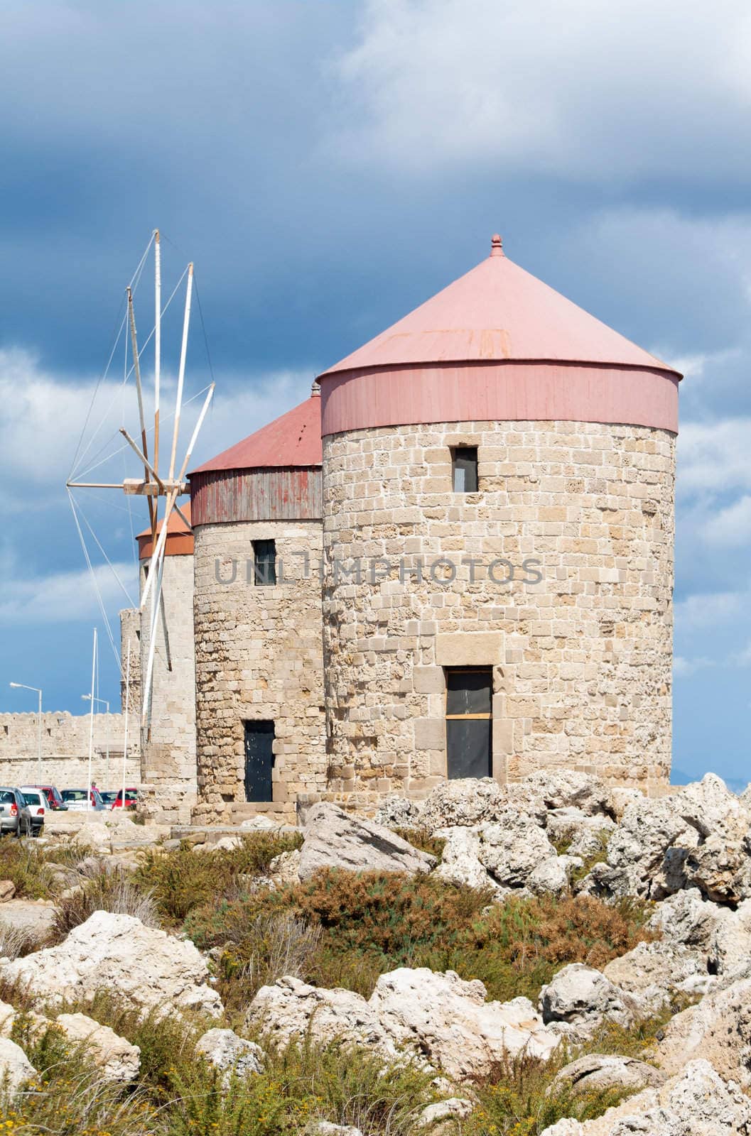 Medieval windmills at Mandraki Harbour in the Dodecanese island of Rhodes, Greece.