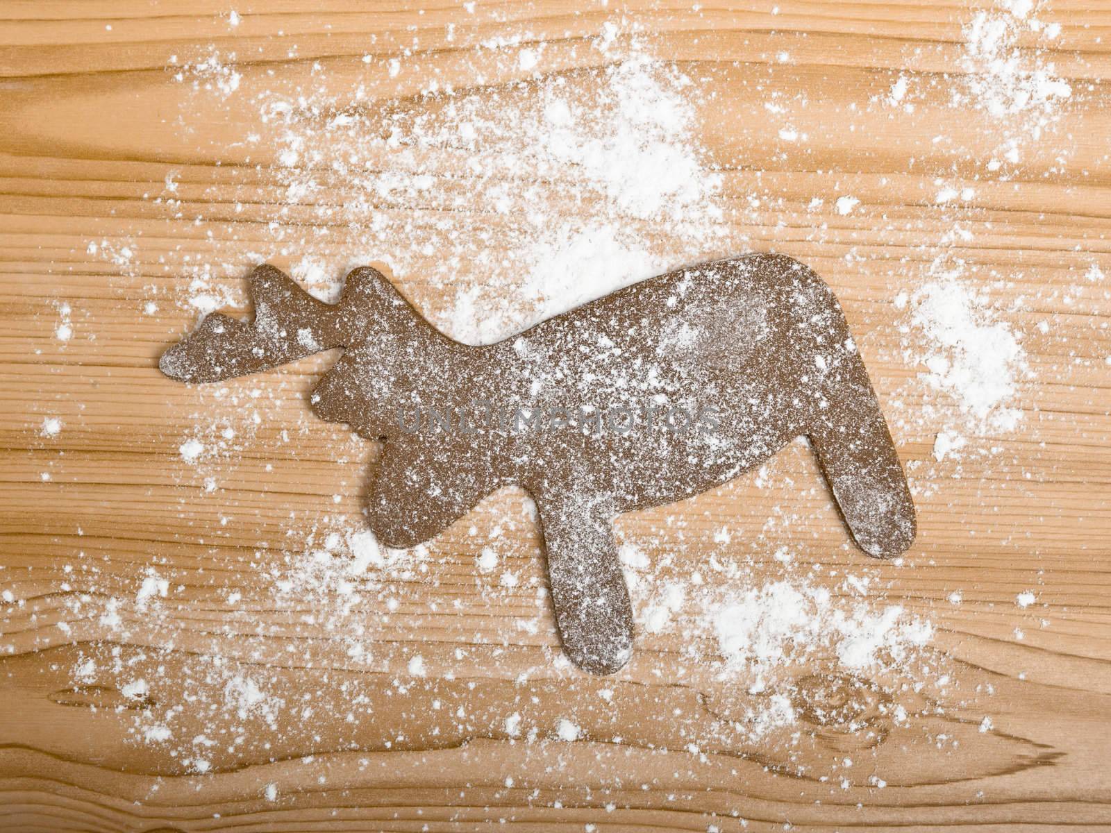 Baking homemade Gingerbread christmas cookies with a shape of a reindeer
