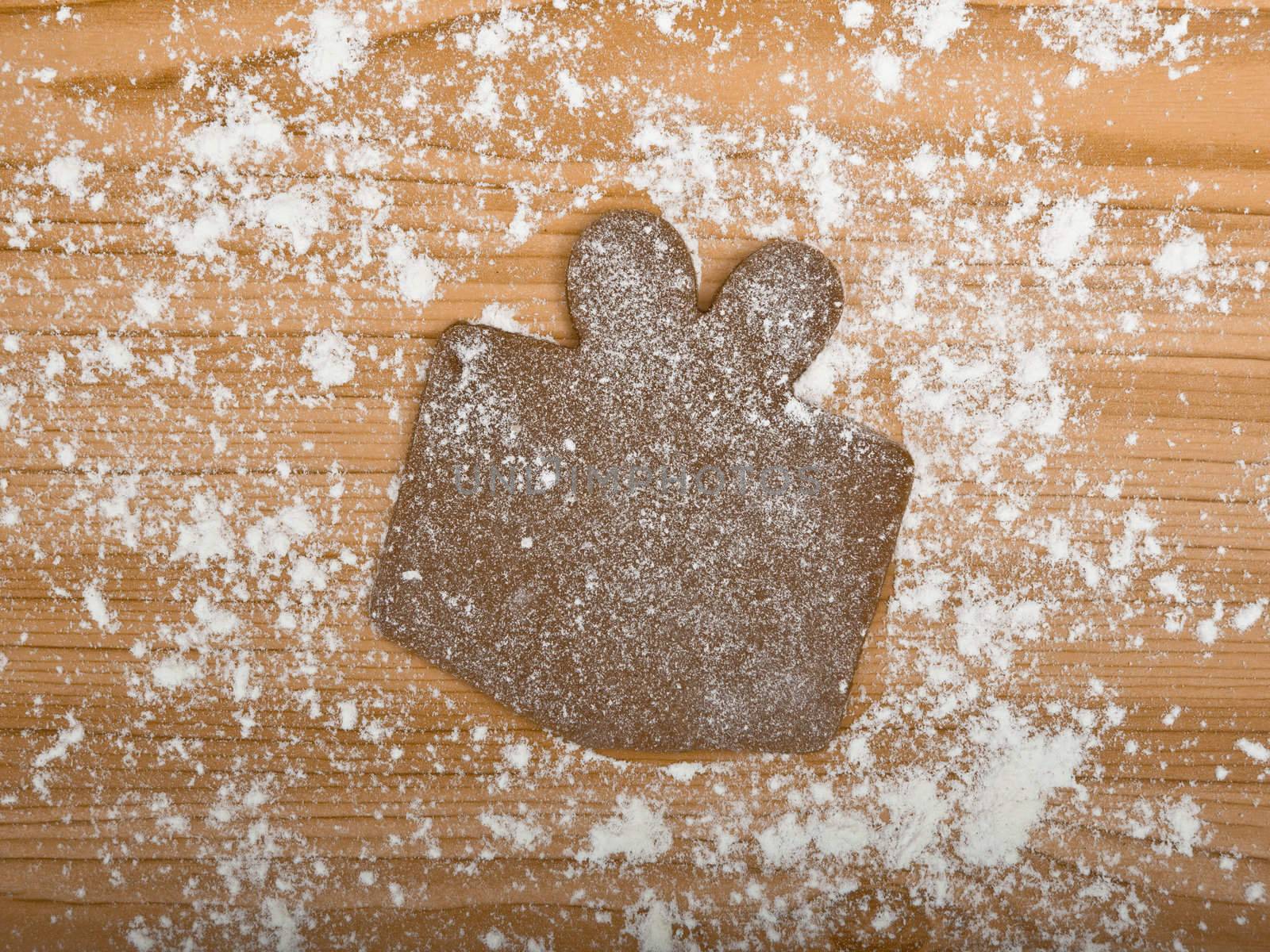 Baking homemade Gingerbread christmas cookies with a shape of a gift