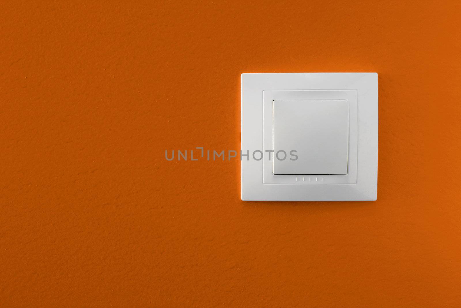 Simple light switch on a orange wall 