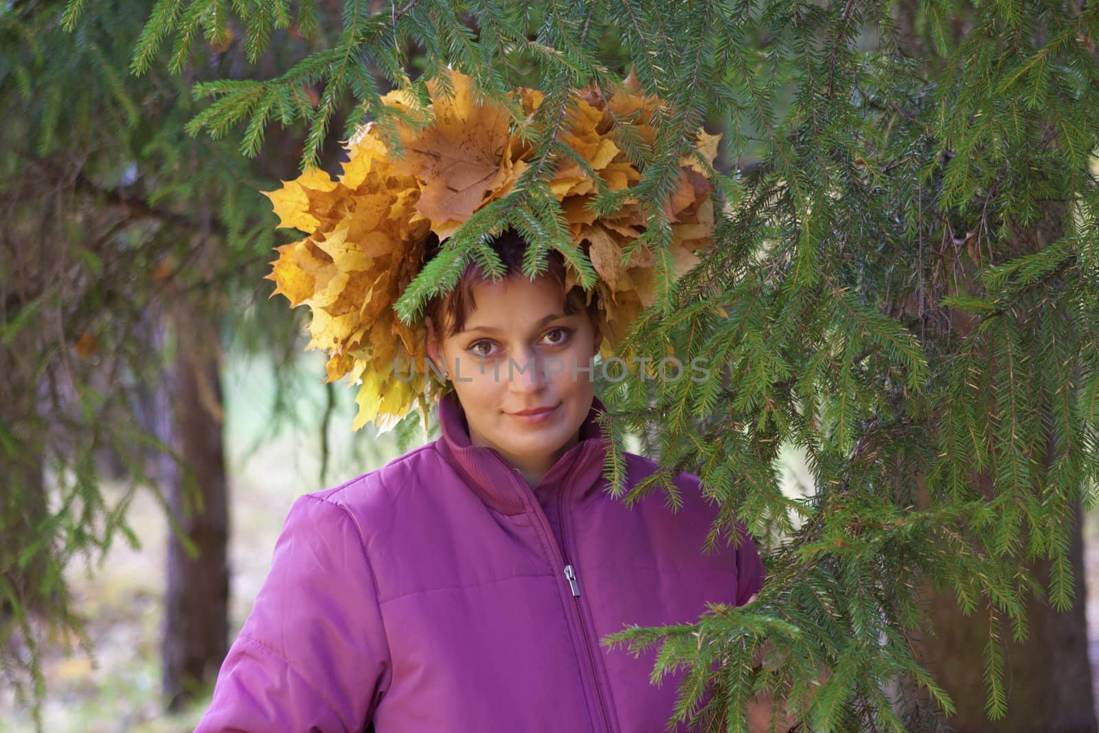 Portrait of beautiful girl in wreath of leaves
