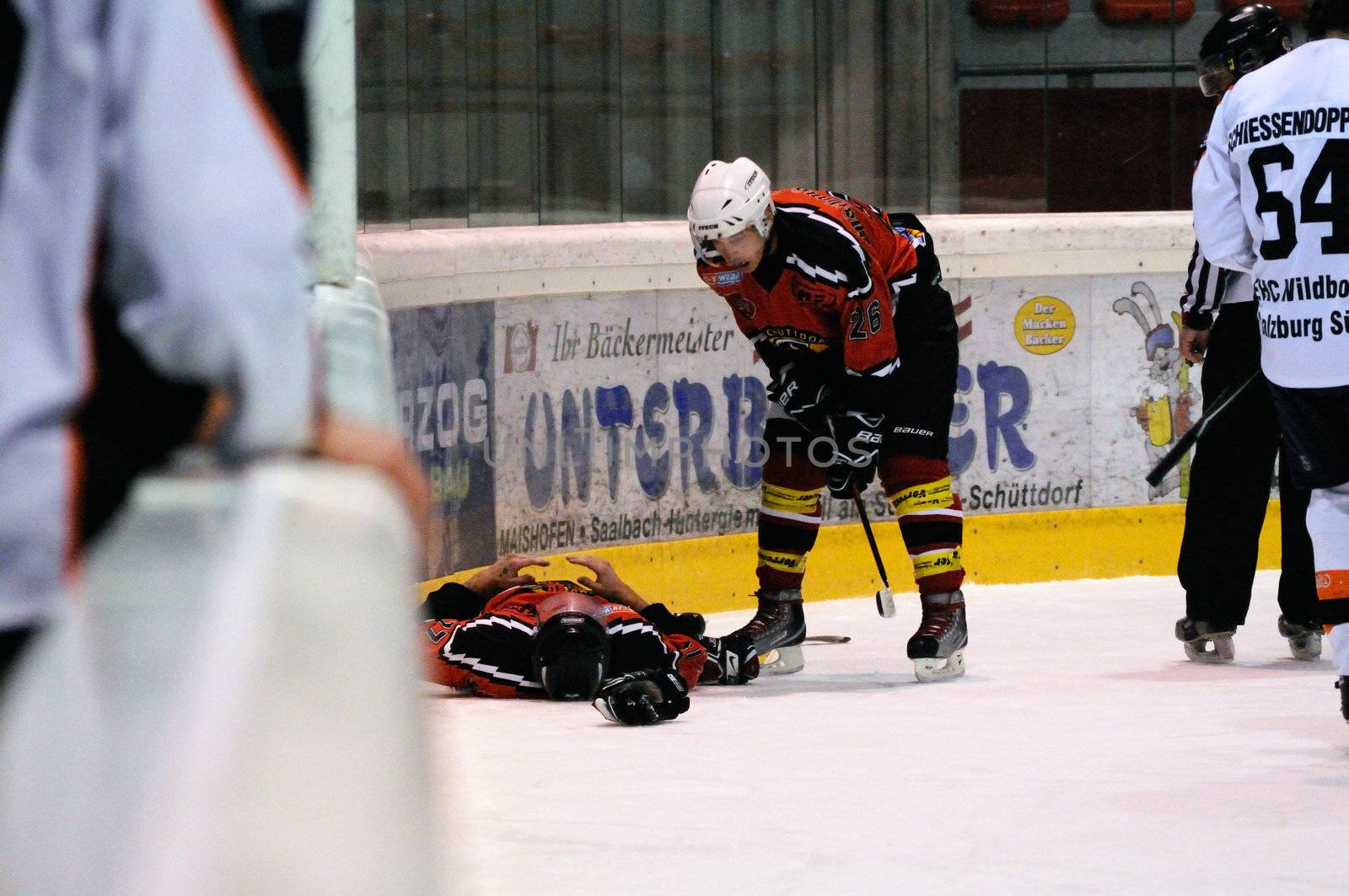 ZELL AM SEE, AUSTRIA - MARCH 19: Salzburg hockey League. Injured Schuettdorf player after hard hit. Game SV Schuettdorf vs Salzburg Sued  (Result 10-4) on March 19, 2011, at the hockey rink of Zell am See.