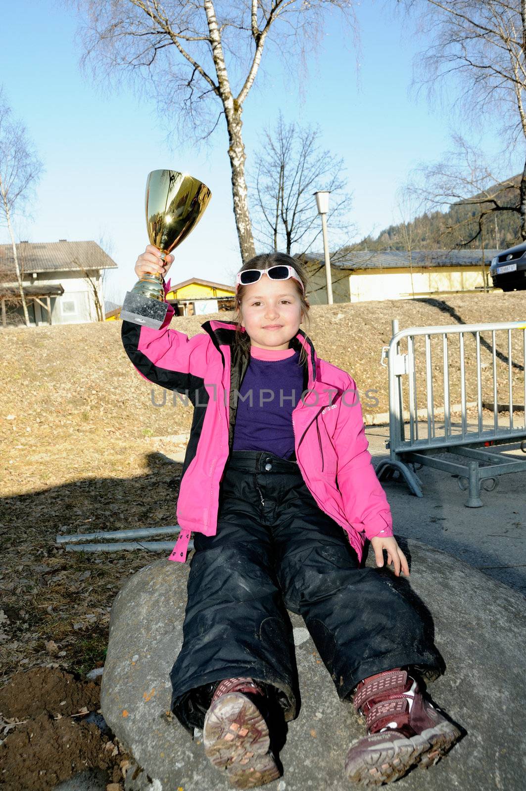 KAPRUN AUSTRIA - MARCH 5: Maiskogel Fanlauf 2011. Unidentified girl holding her trophy at charity ski race with many celebrities in austria on March 5, 2011 at the Maiskogel in Kaprun, Austria