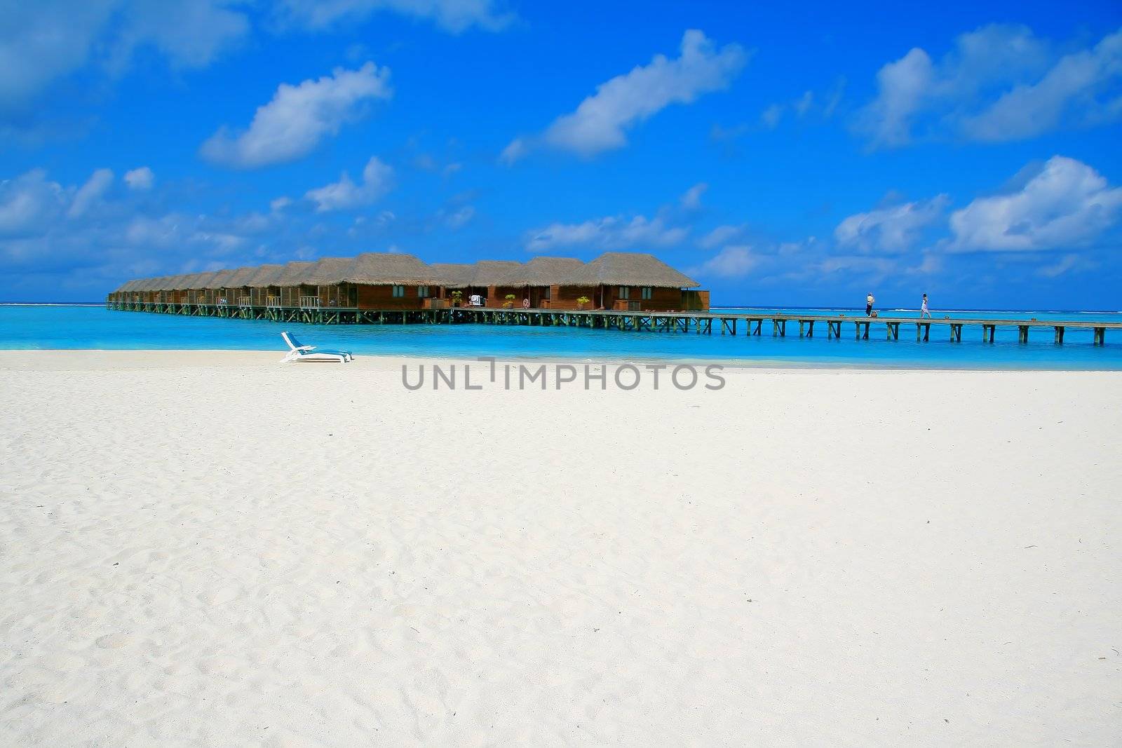 Water villas and turquoise water on Meeru Island, Maldives