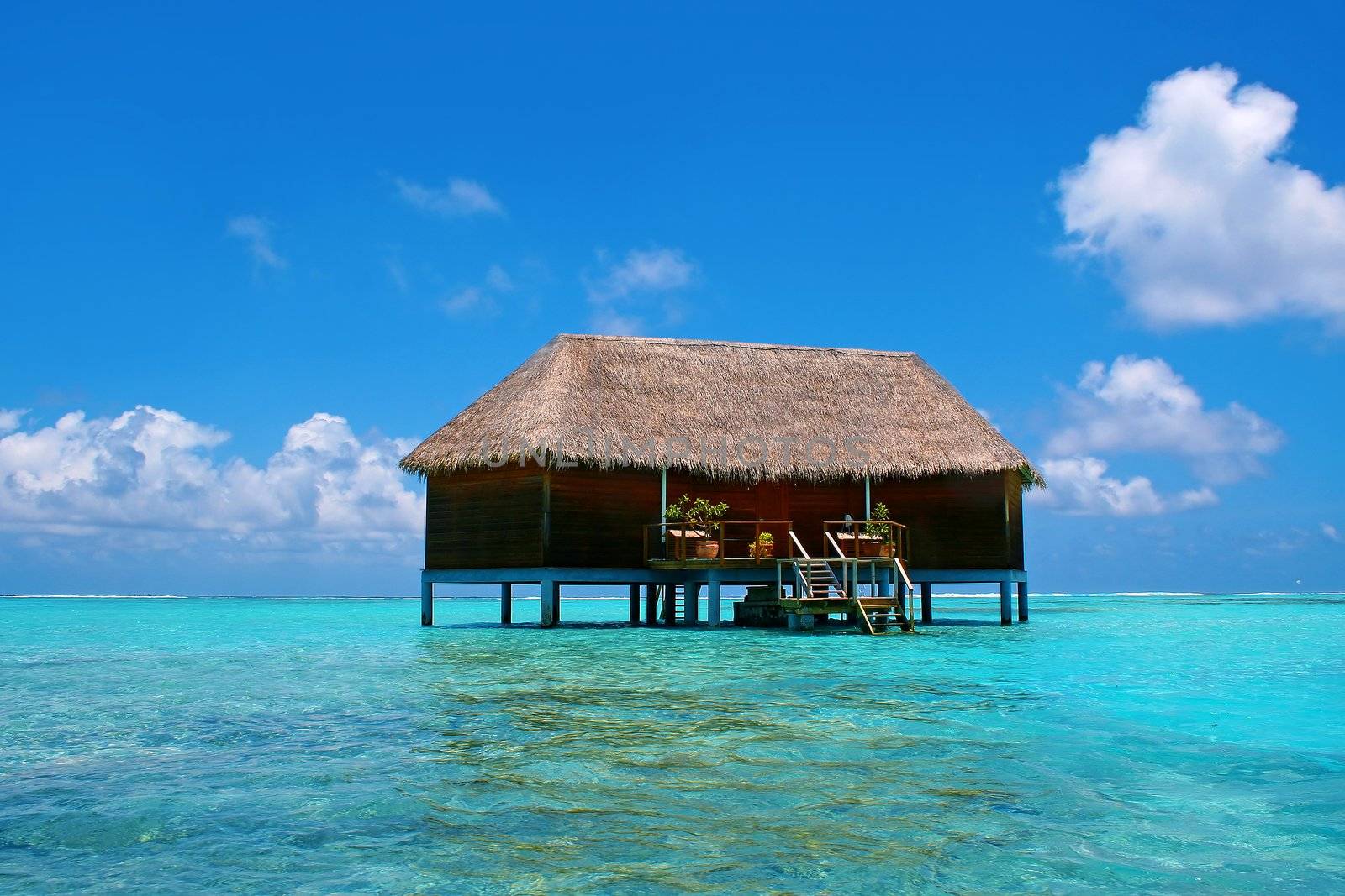 Water villa and turquoise water on Meeru Island, Maldives