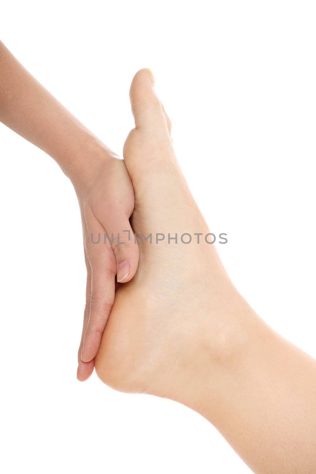 Woman hands giving a foot massage on white background