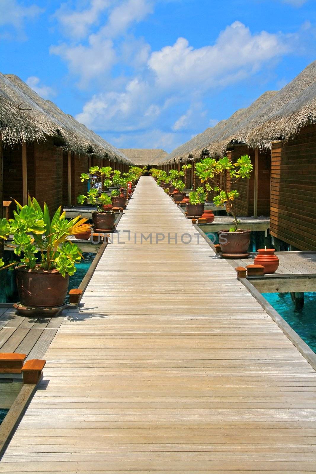 Water villas and turquoise water on Meeru Island, Maldives