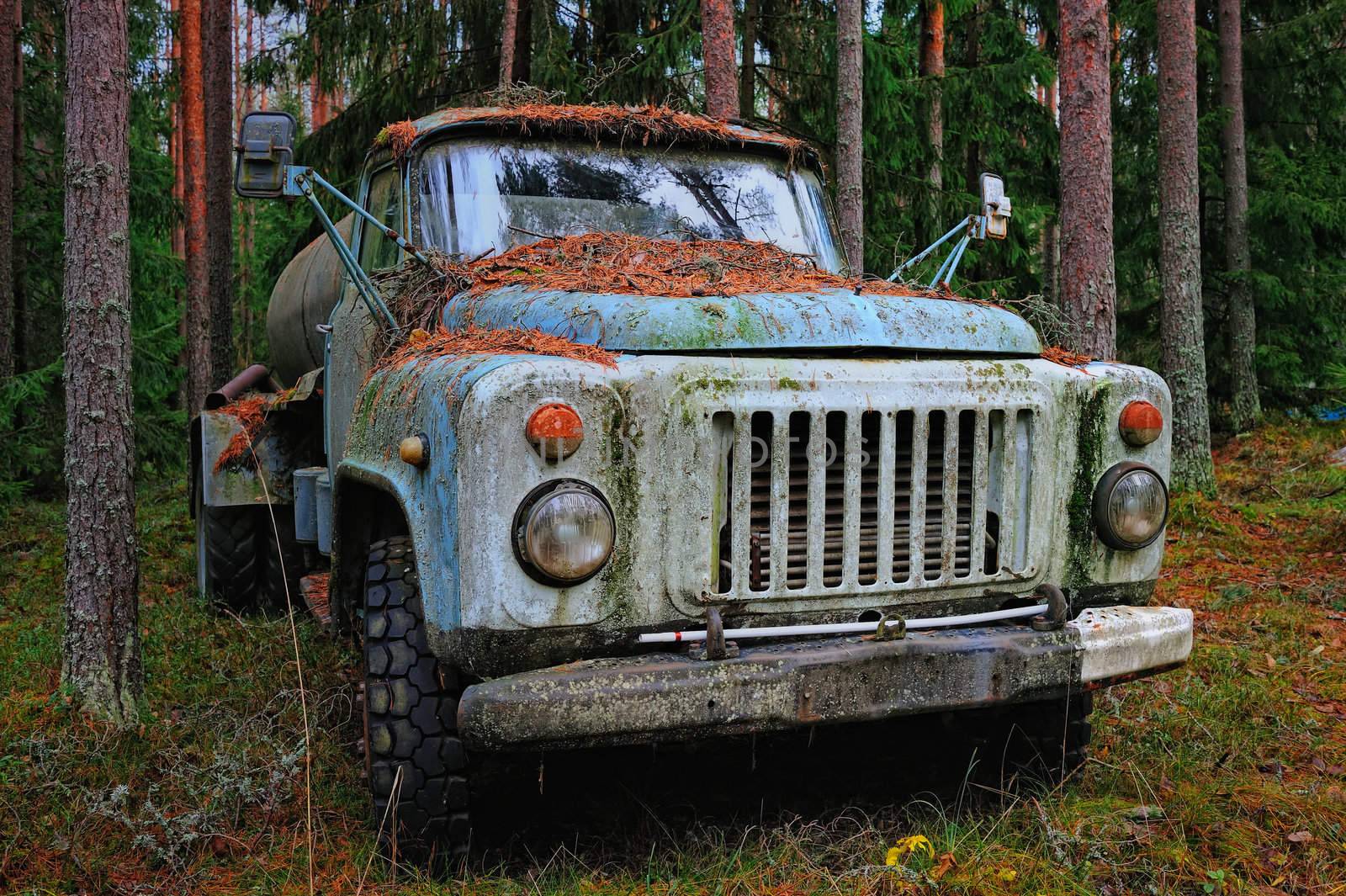 Old tank truck in the coniferous forest