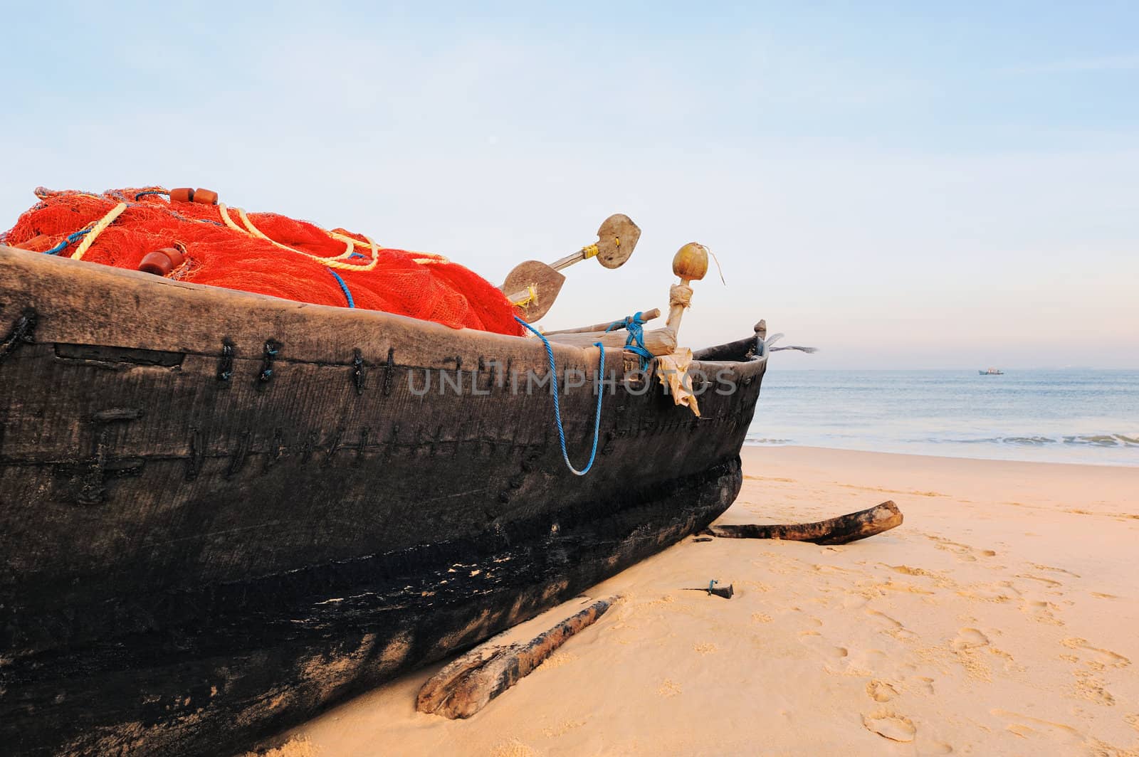 Old fishing boat on the sandy beach in Goa