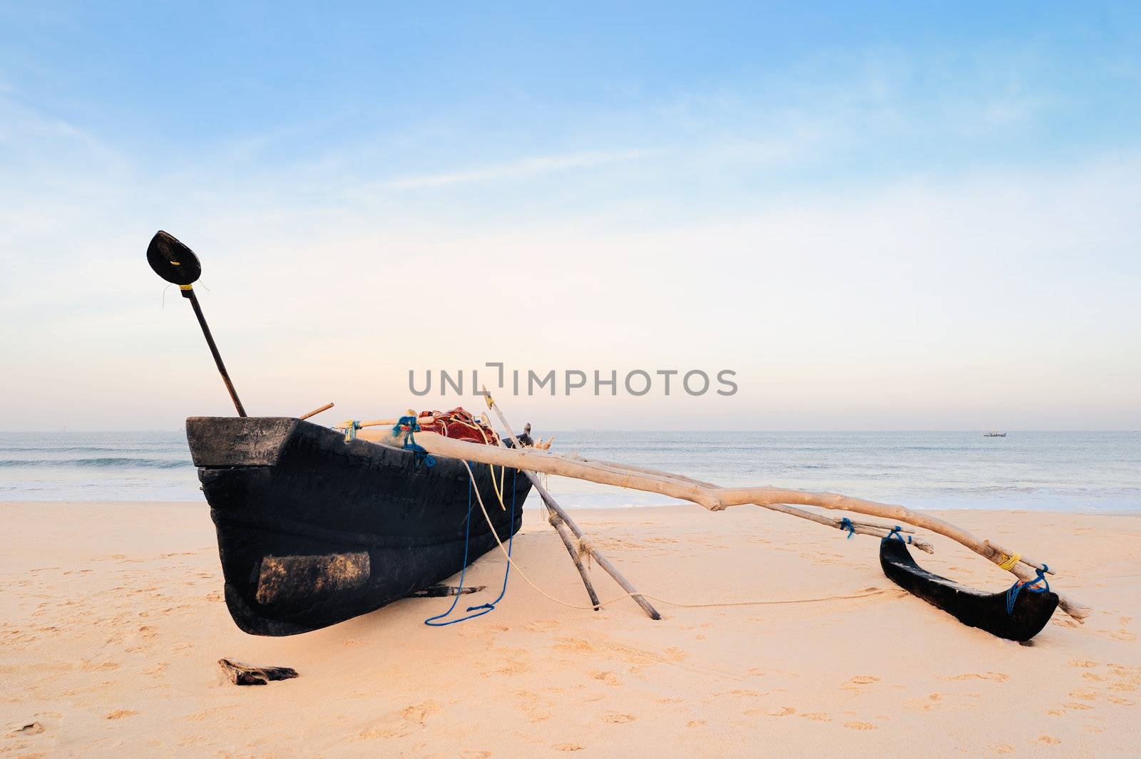 Old fishing boat on the sandy beach in Goa