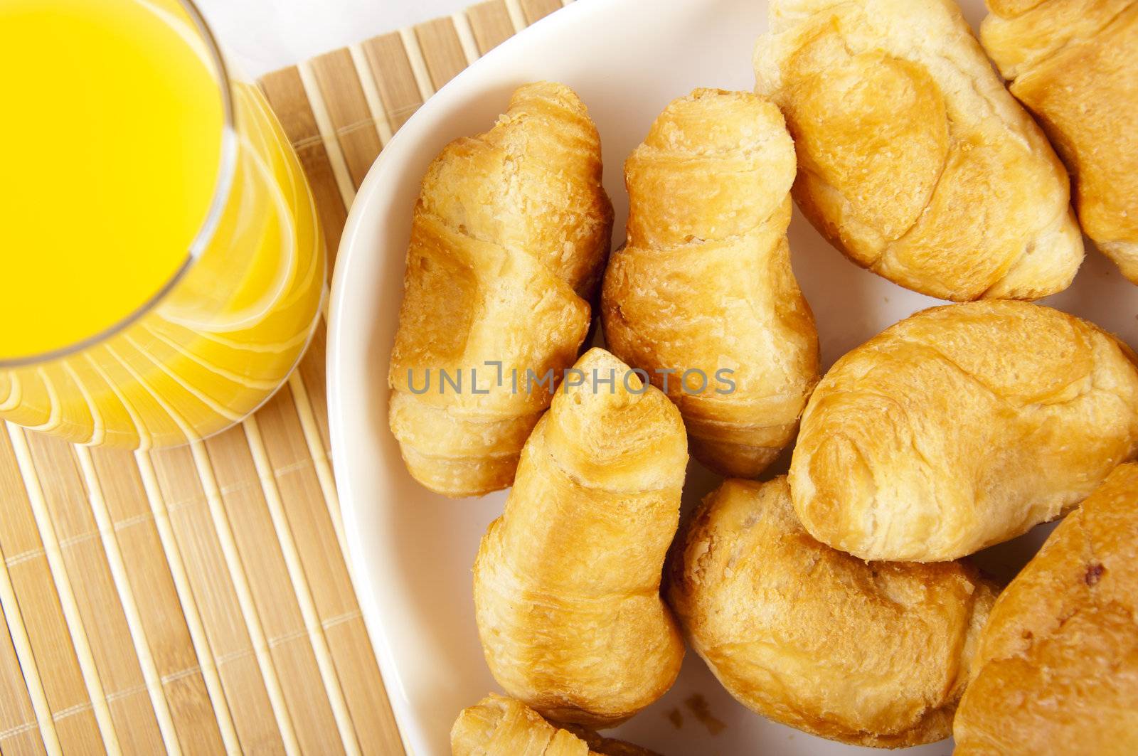 light Breakfast: orange juice, croissants on a table