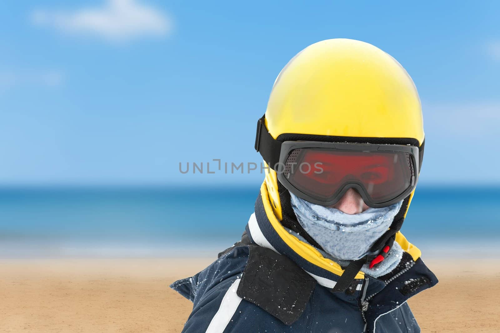 Girl in skiing outfit against summer beach