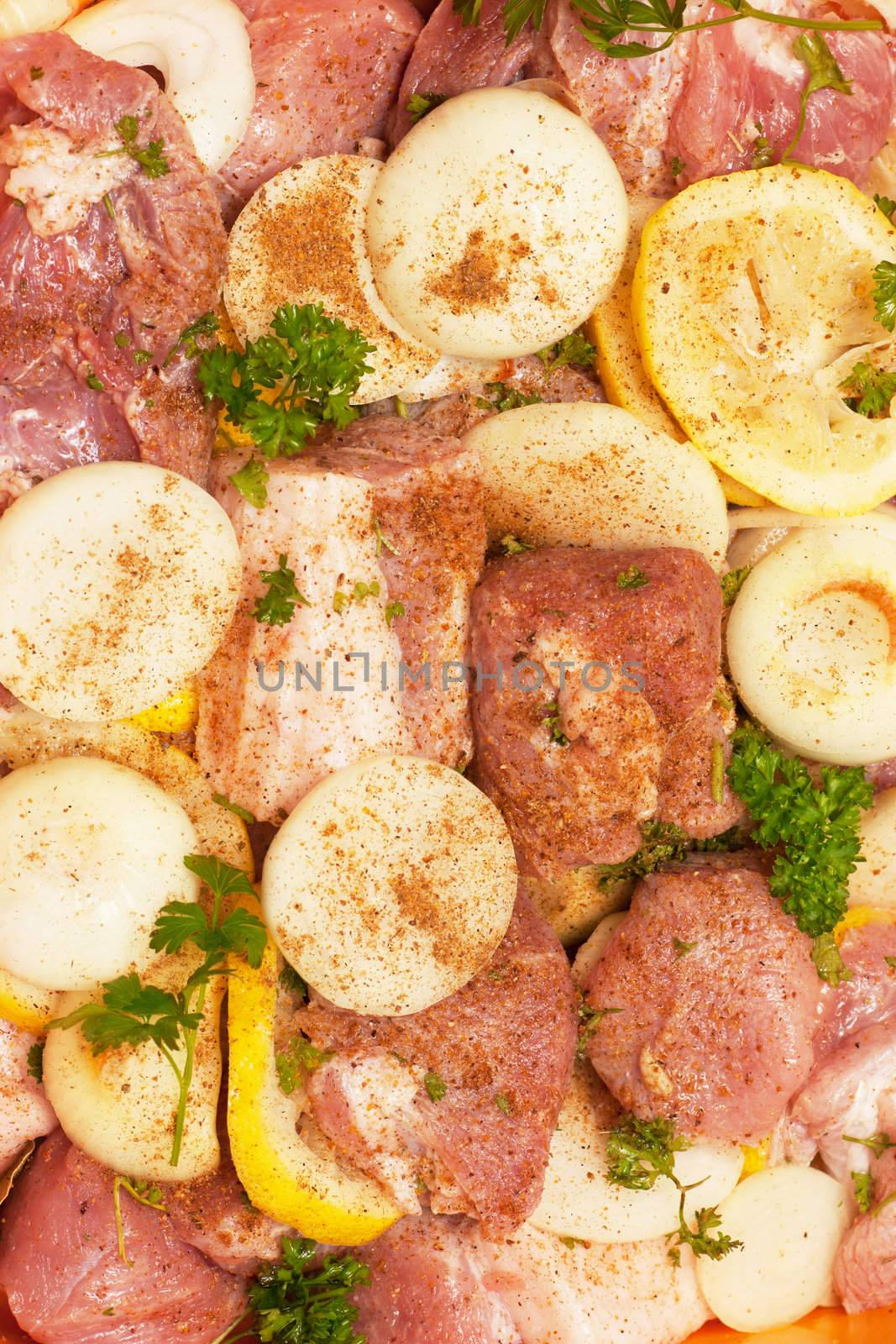 Closeup view of spiced uncooked meat with fresh parsley