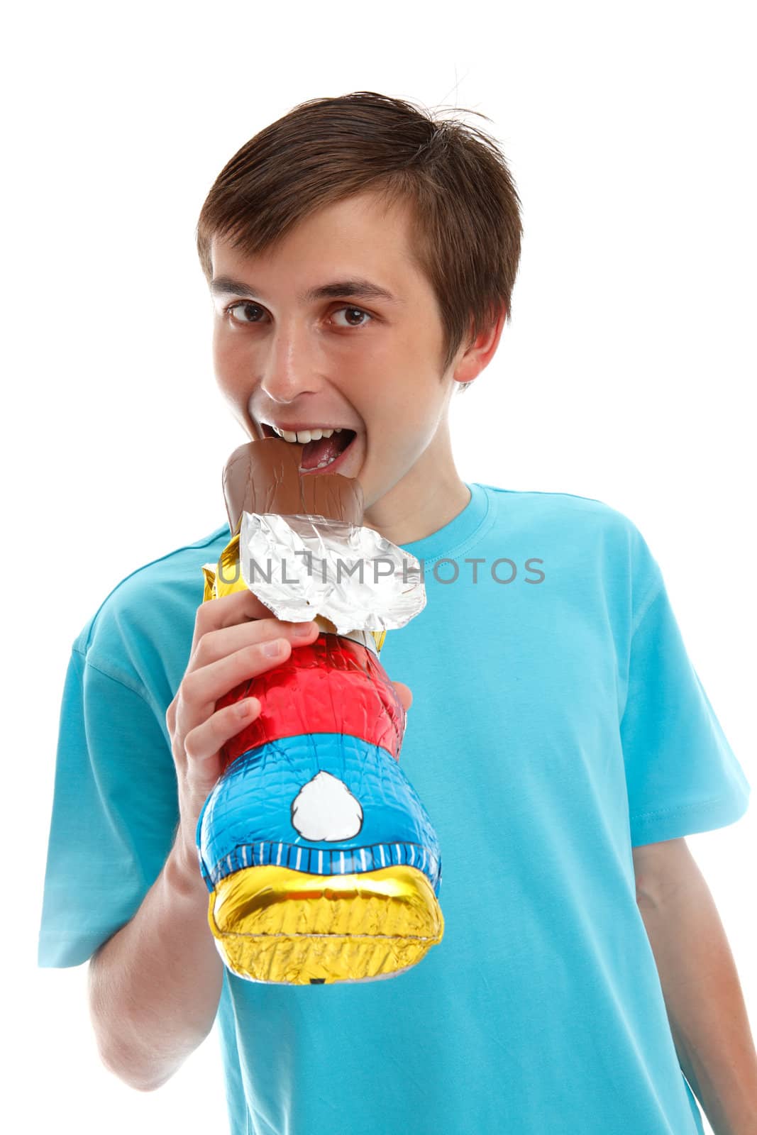 Smiling happy boy eating a milk chcolate  easter rabbit. White background