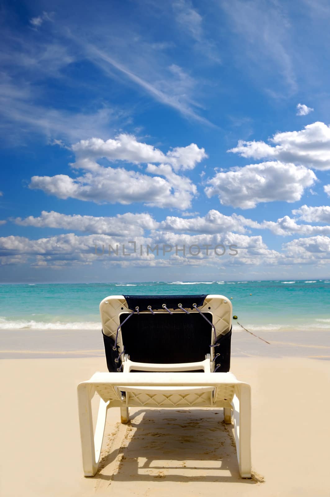 A sunbed near the water at exotic beach. Dominican Republic, Punta Cana.