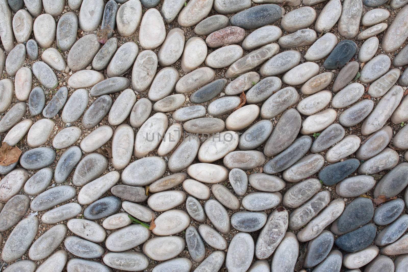 Cobblestone background from the floor in a medieval alley in Rhodes Old Town, Greece.