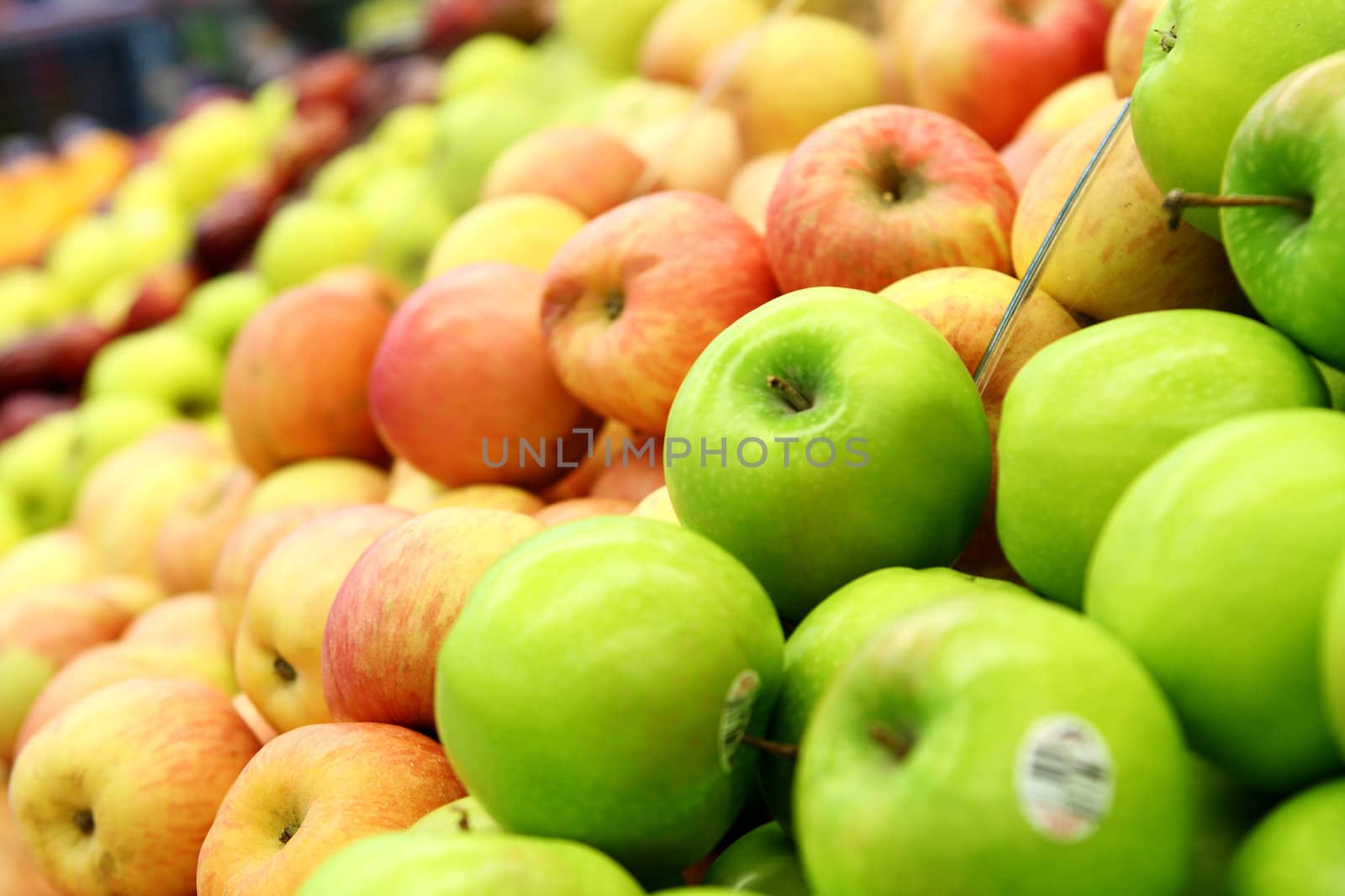 green and red apples at the farmers market  by cozyta