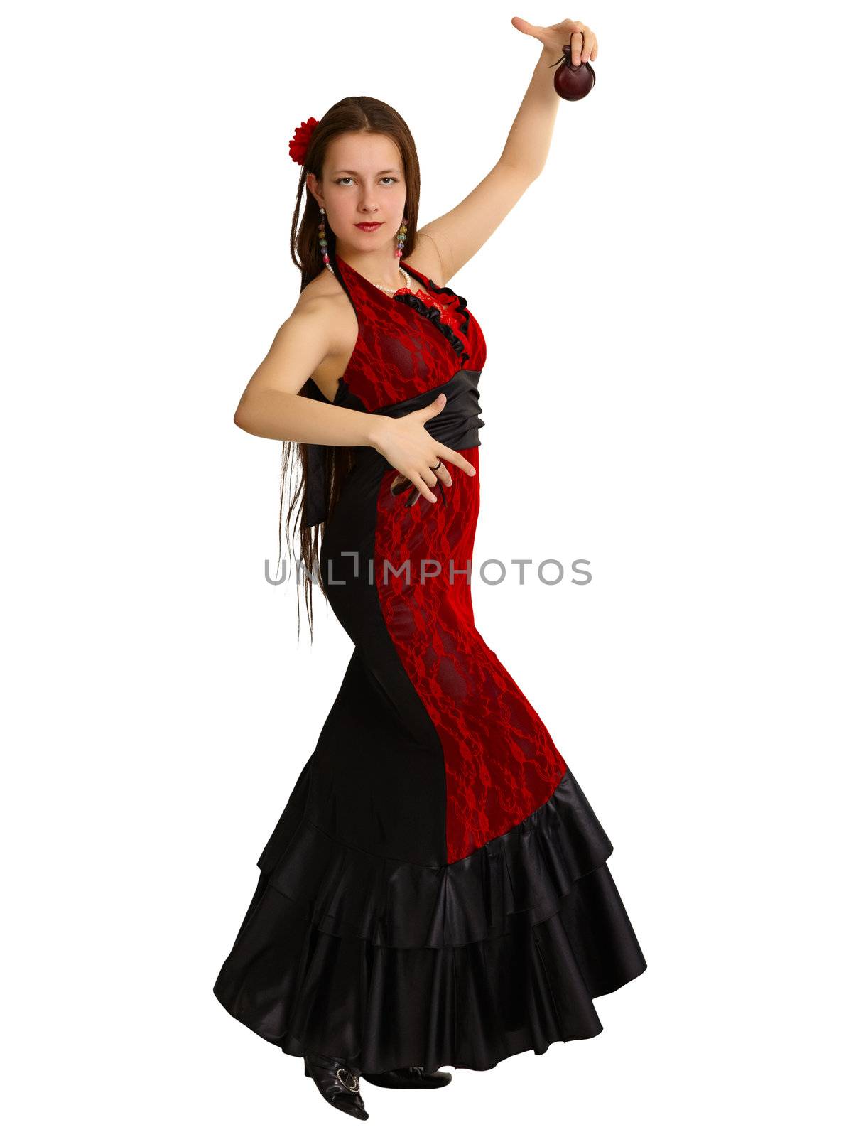 A young girl performs Spanish dance with castanets isolated on white background