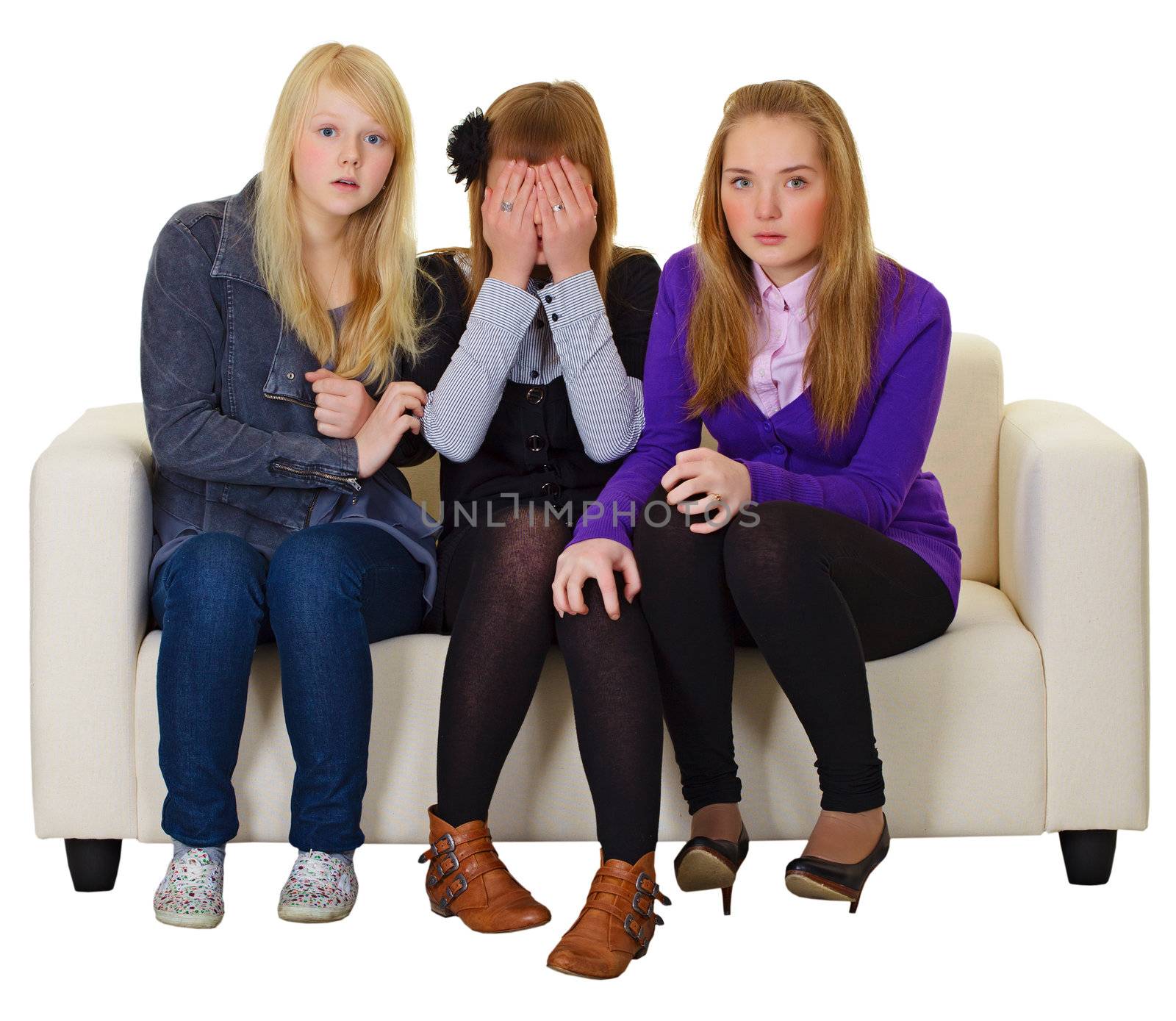 The three girls look a horror movie on the couch