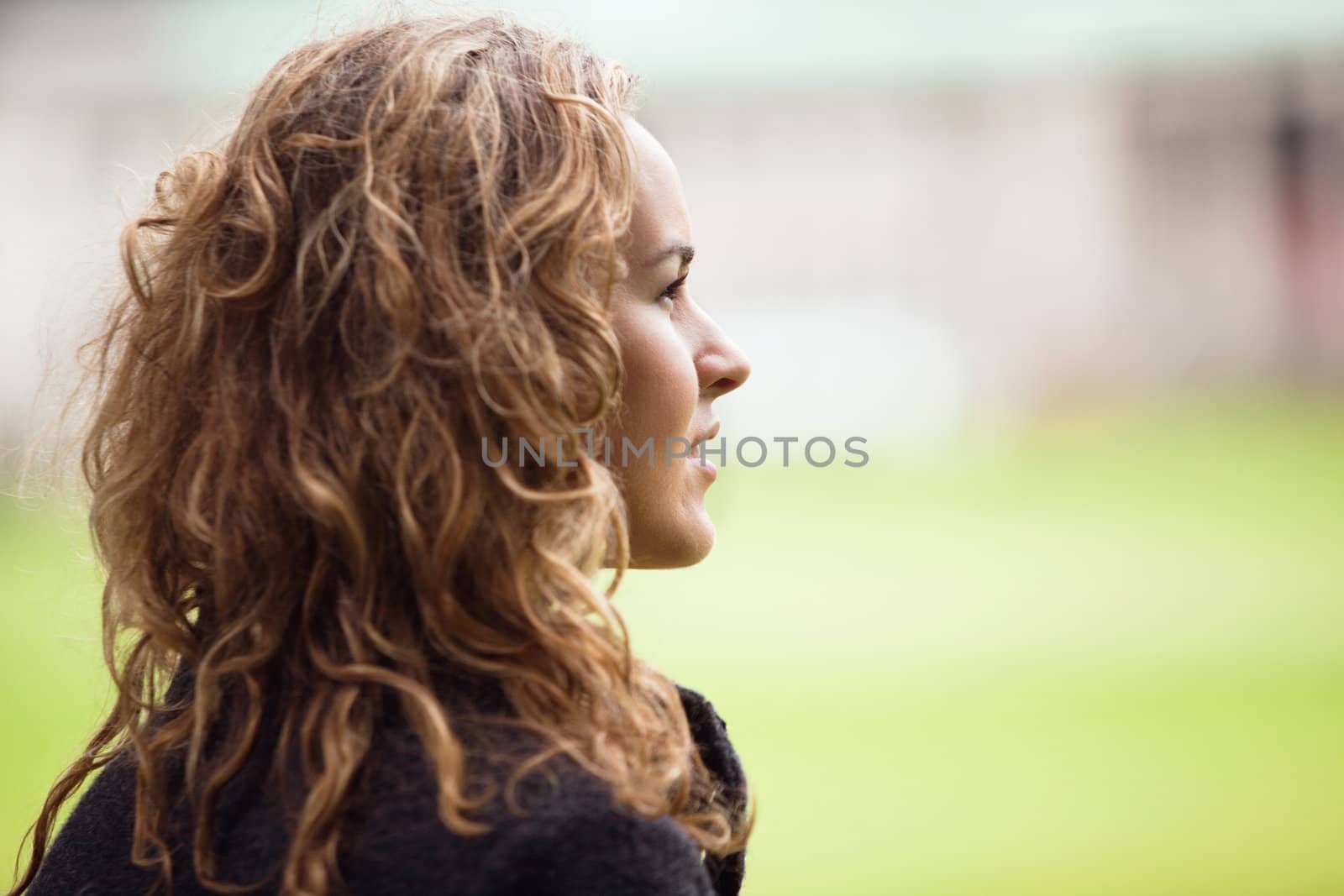 Contemplative young woman looking away by leaf