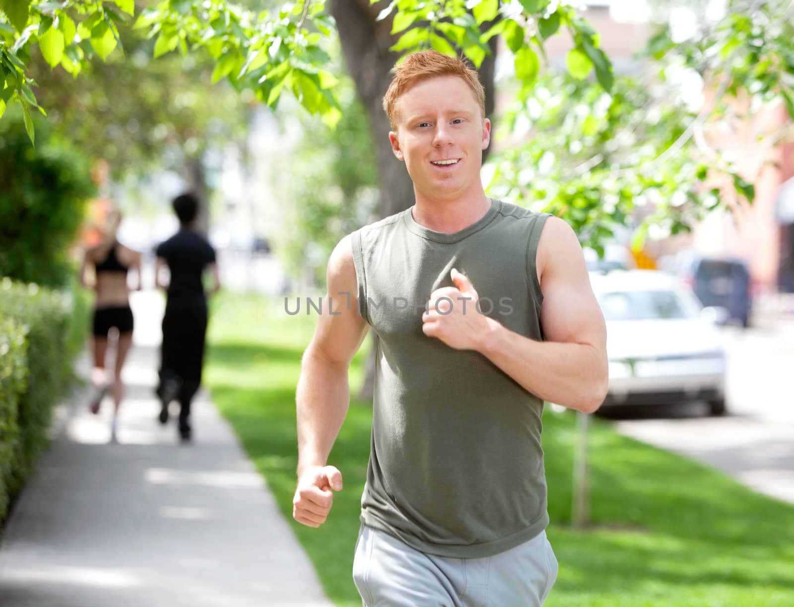 People running on walkway by leaf