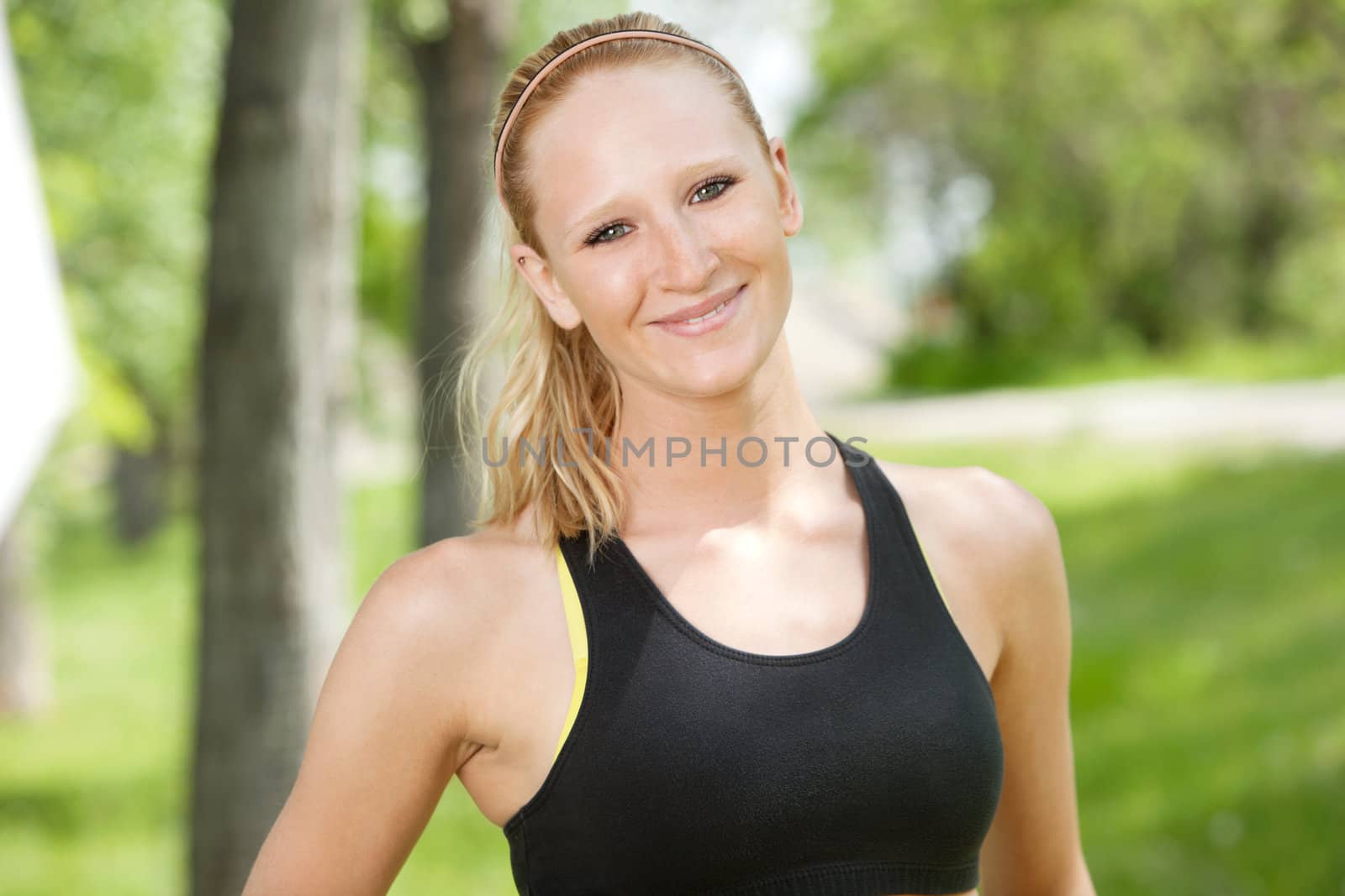 Close-up of woman in sportswear by leaf