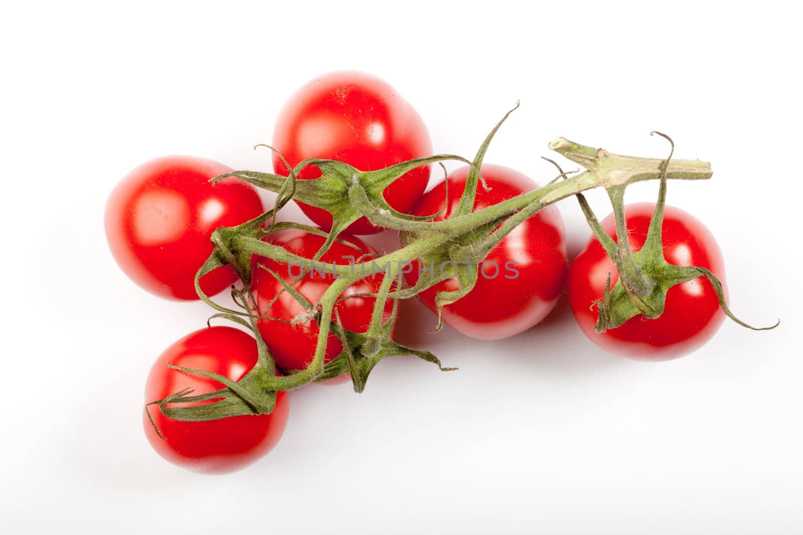 some cherry tomatoes connected together on ther stem