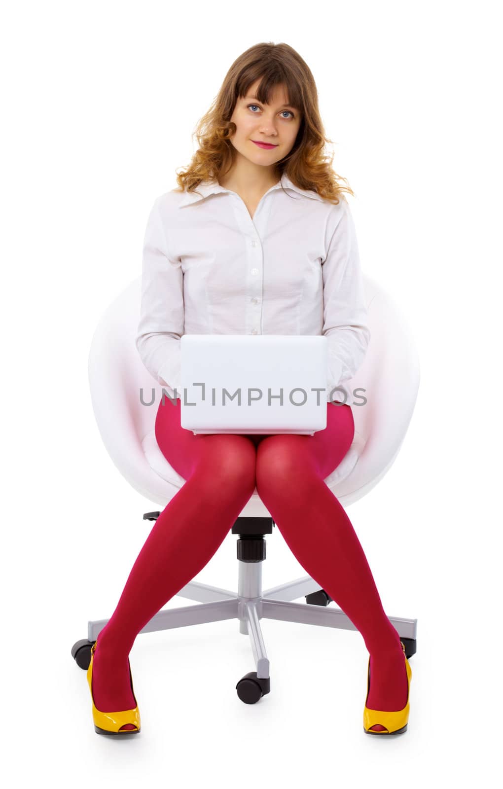 A young woman with a small laptop sitting in a chair isolated on white background