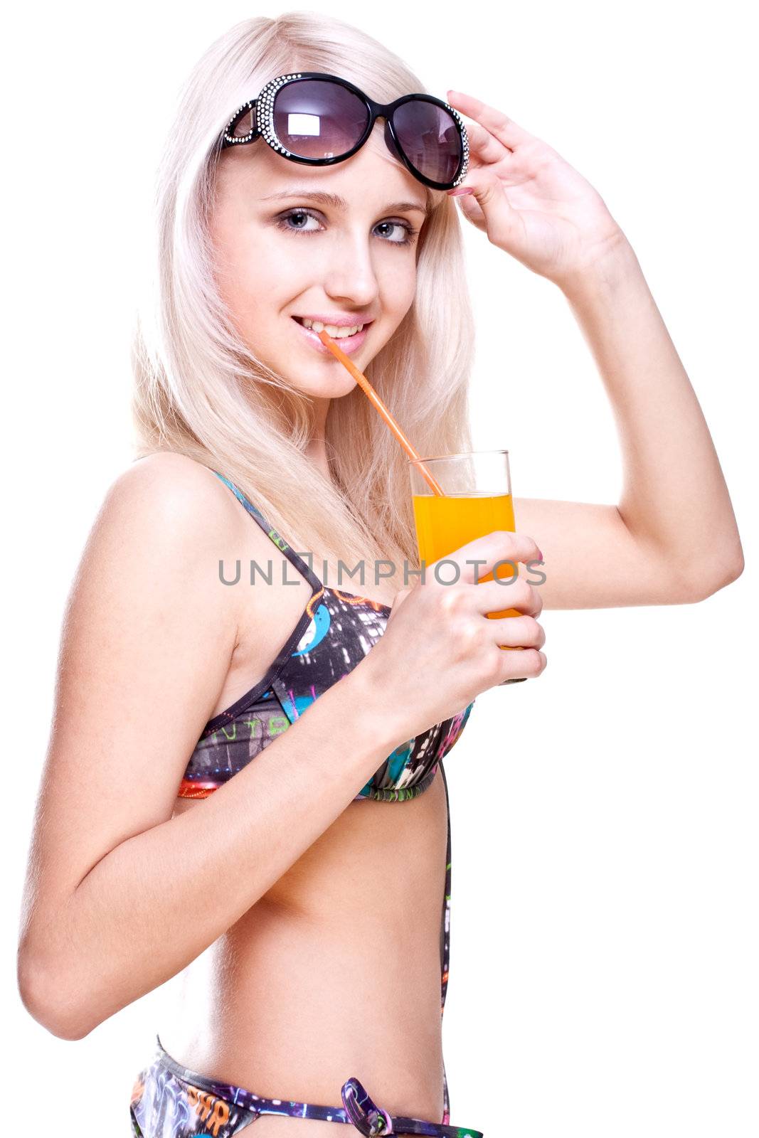 beautiful women in swimsuit with a glass of juice on a white background isolated