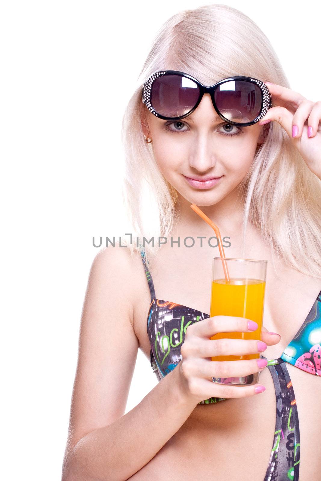 beautiful women in swimsuit with a glass of juice on a white background isolated