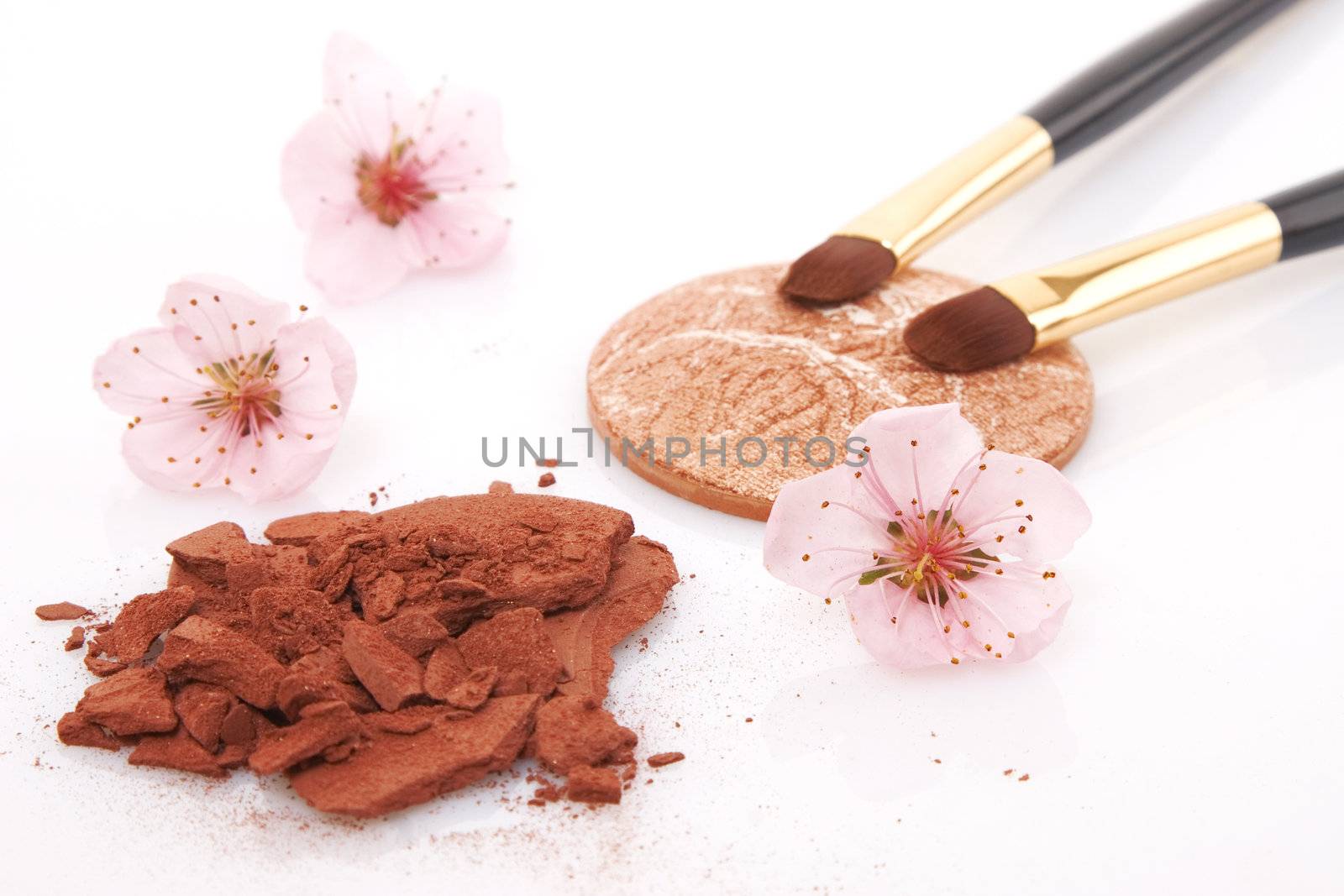 brown powder for makeup, flowers and two brush
