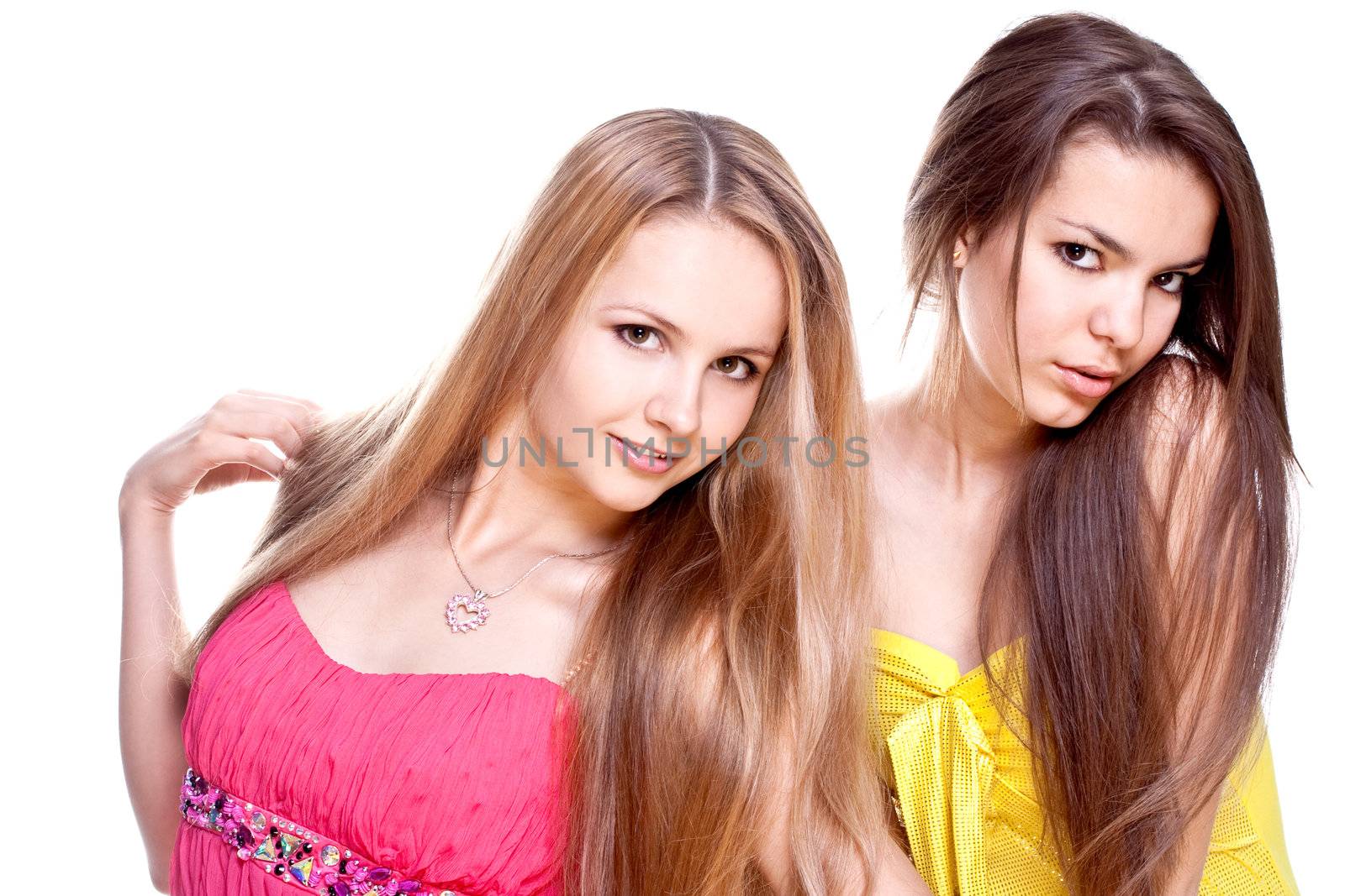 two beautiful women in a colored dress on a white background isolated