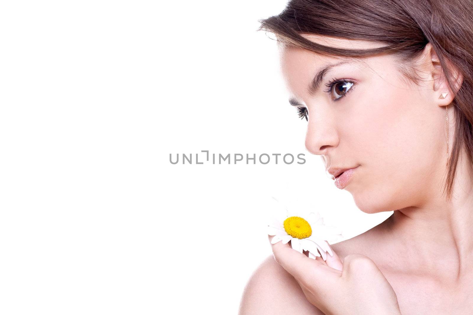 Close-up woman face with yellow camomile on a white background