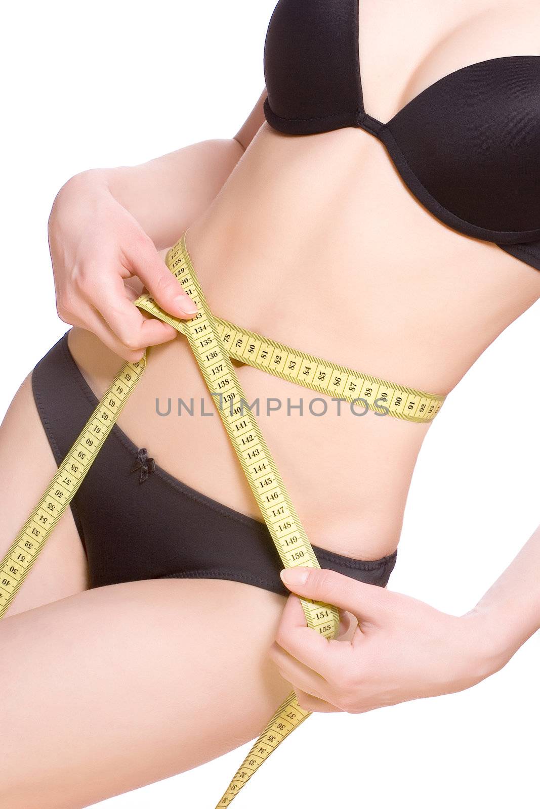 beautiful woman in lingerie measuring her waist