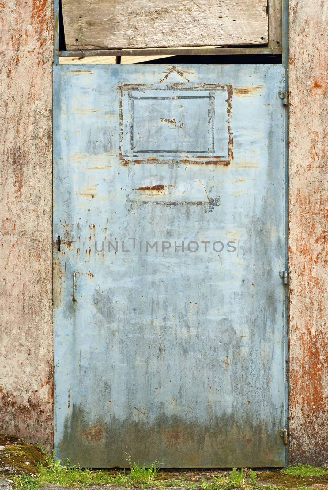 Old abandoned door of metallic in grunge style