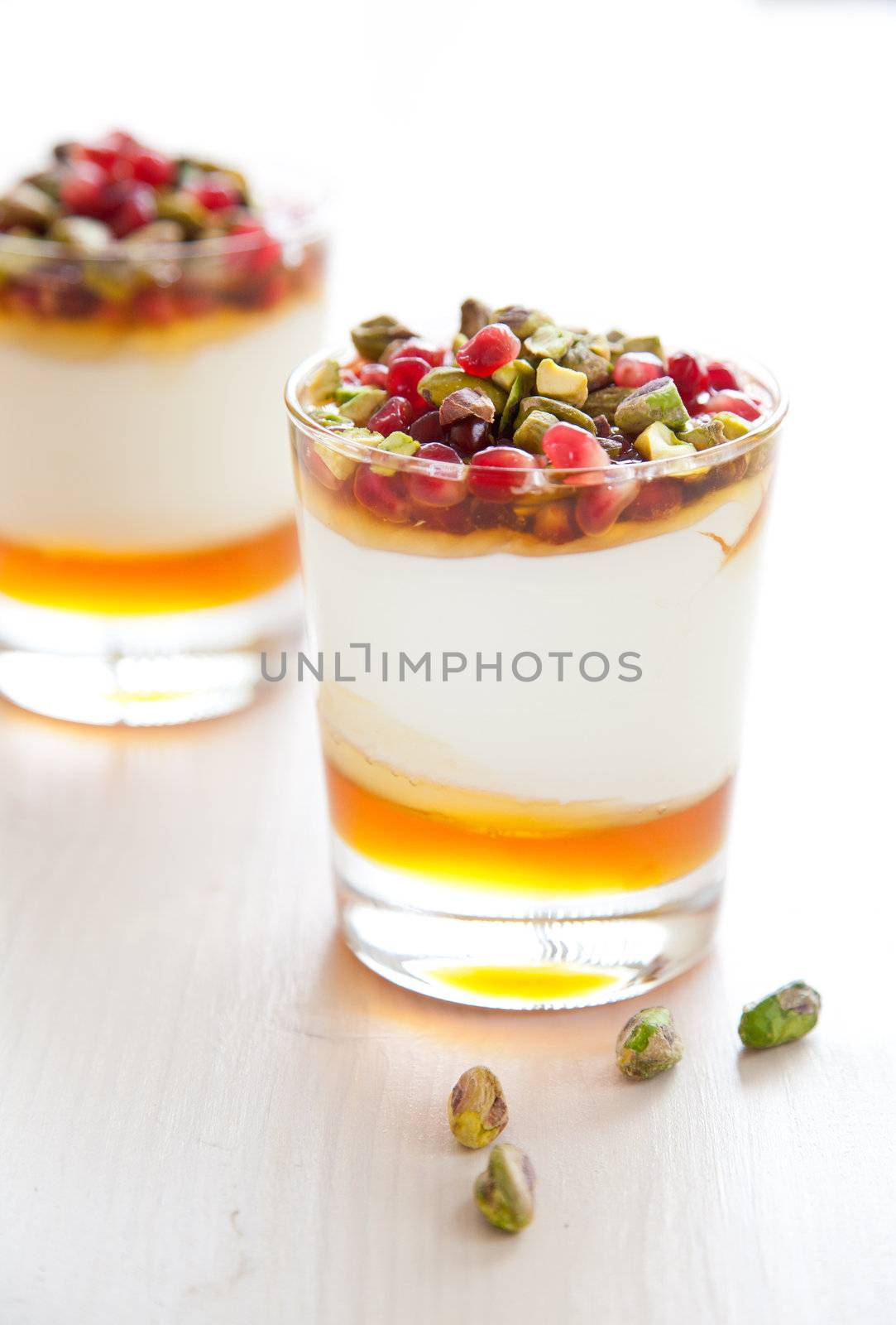 Yogurt dessert with honey, pomegranate and roasted pistachio