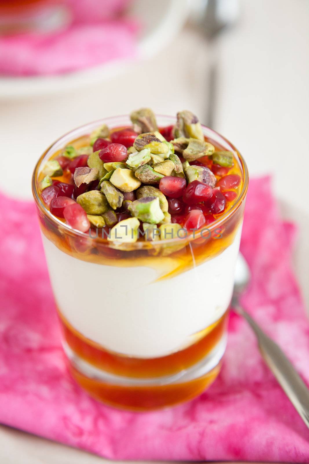 Yogurt dessert with pistachio and pomegranate