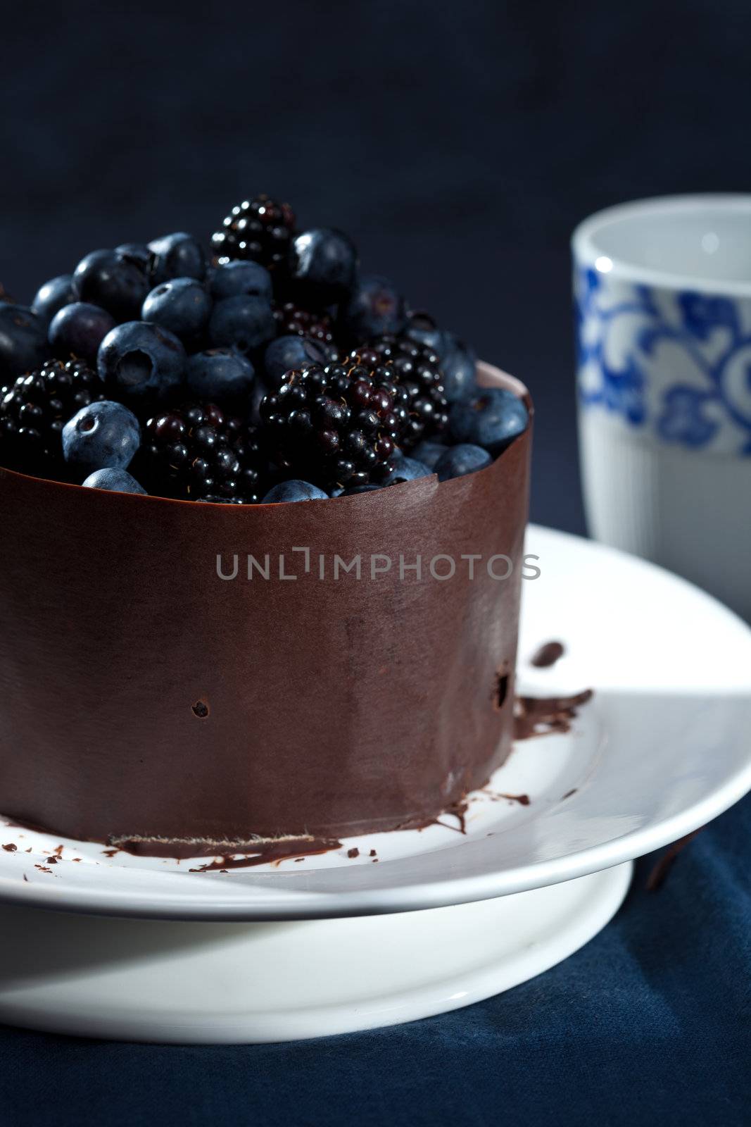 A pretty and festive chocolate cake with blueberries and blackberries.