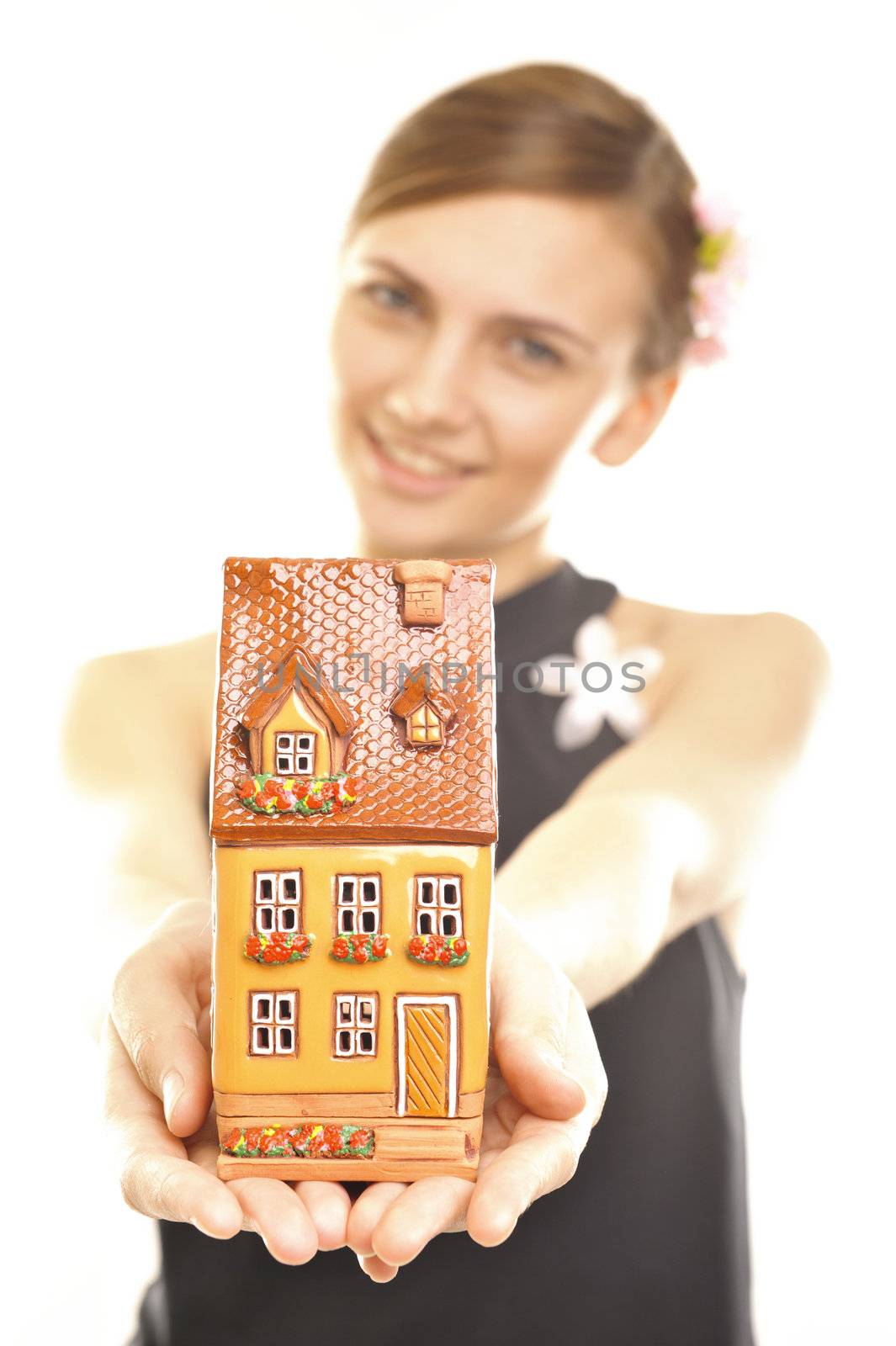 Concept image of a woman holding house isolated on white