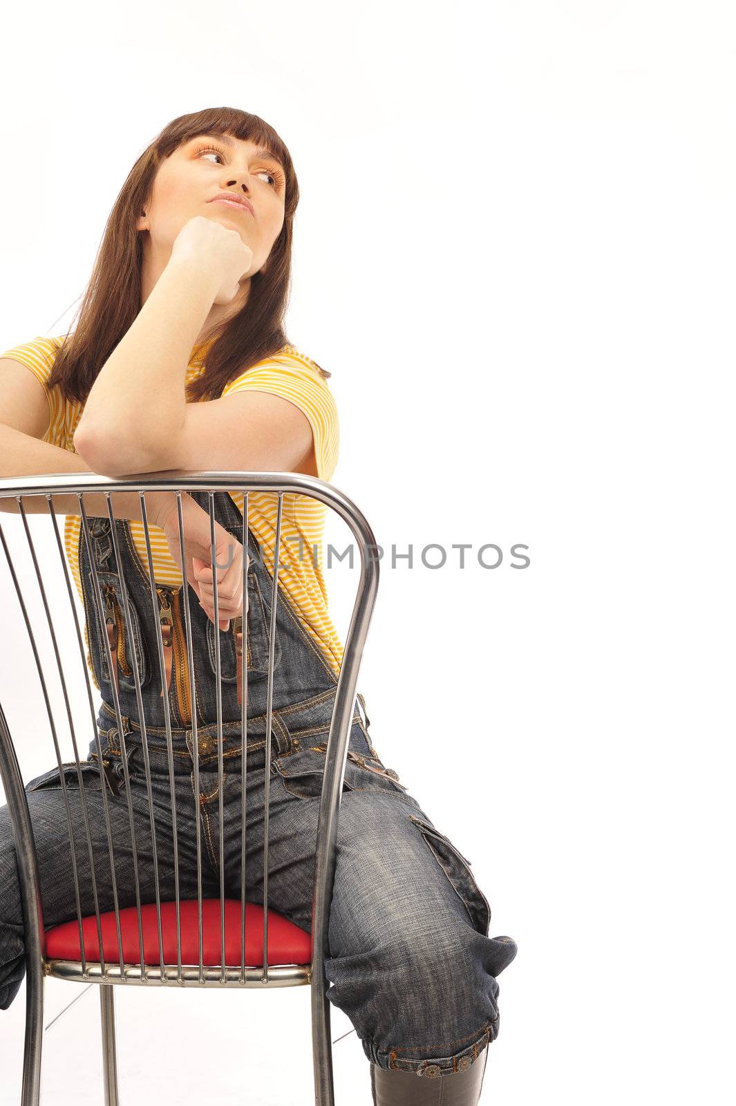 Portrait of a young brunette posing on the chair