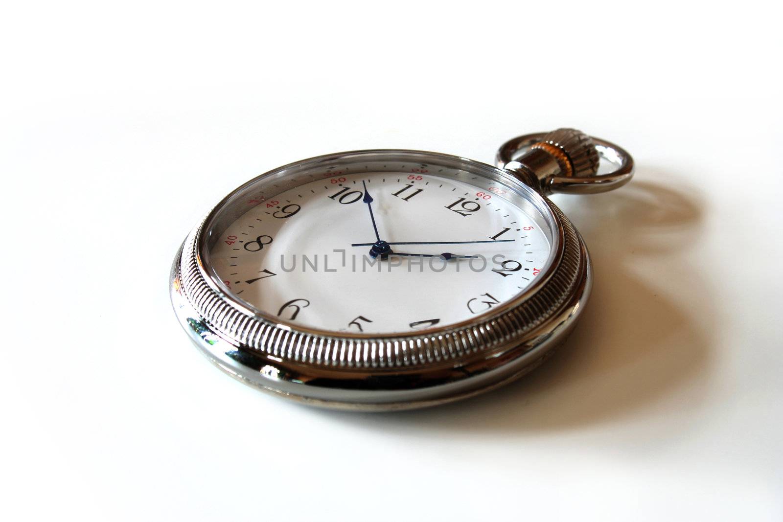 pocket watch lying on a bright background