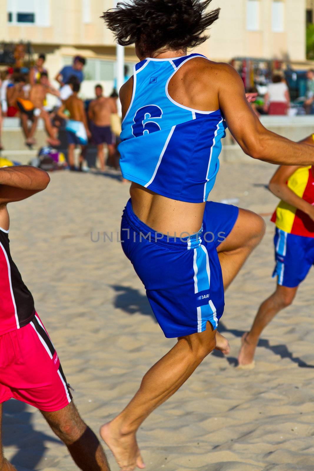 CADIZ, SPAIN - JULY 19: Unidentified players compete in a match between Zonabalonmano.com and CadizSur Seguros BMPY in the 19th league of beach handball of Cadiz on July 19, 2011 in Cadiz, Spain