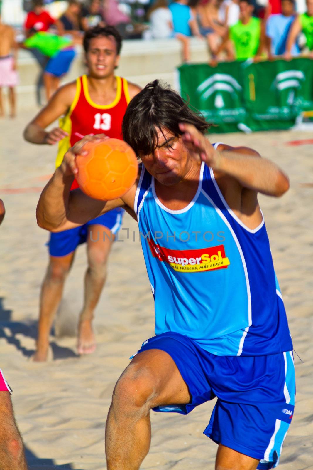 CADIZ, SPAIN - JULY 19: Unidentified players compete in a match between Zonabalonmano.com and CadizSur Seguros BMPY in the 19th league of beach handball of Cadiz on July 19, 2011 in Cadiz, Spain