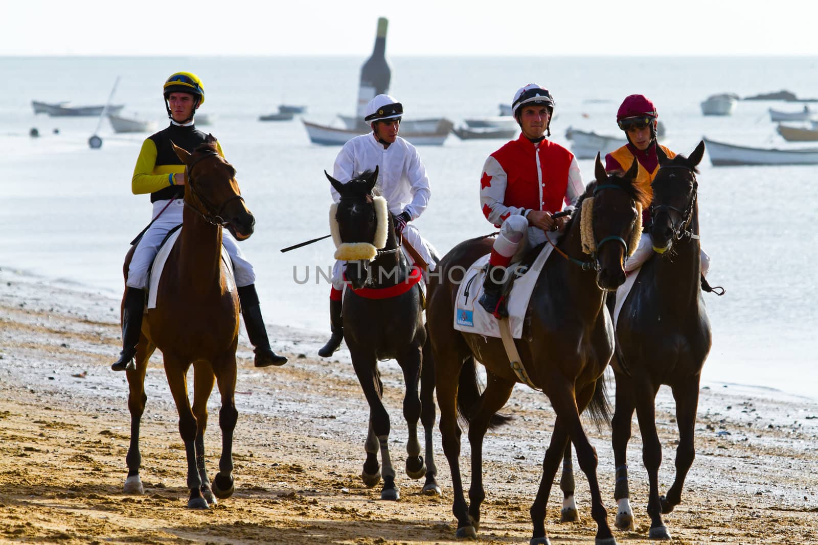SANLUCAR DE BARRAMEDA, CADIZ, SPAIN - AUGUST 10: Unidentified riders at the start of race horses on Sanlucar de Barrameda beach on August 10, 2011 in Sanlucar de Barrameda, Cadiz, Spain.