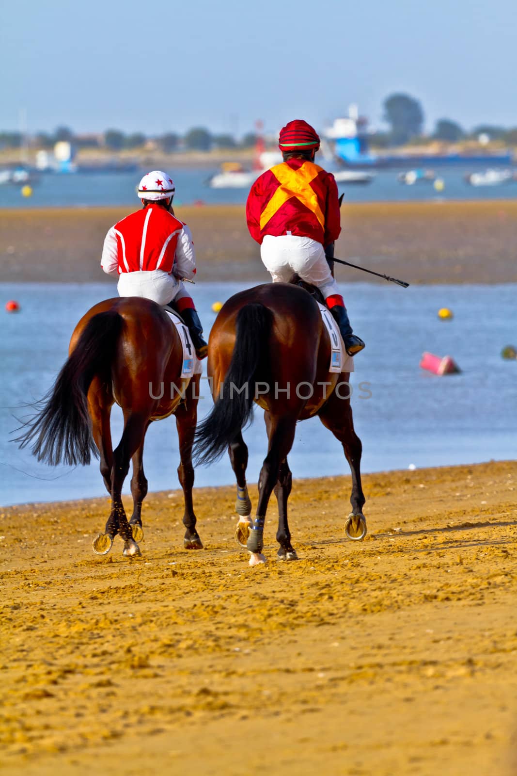 SANLUCAR DE BARRAMEDA, CADIZ, SPAIN - AUGUST 10: Unidentified riders at the start of race horses on Sanlucar de Barrameda beach on August 10, 2011 in Sanlucar de Barrameda, Cadiz, Spain.