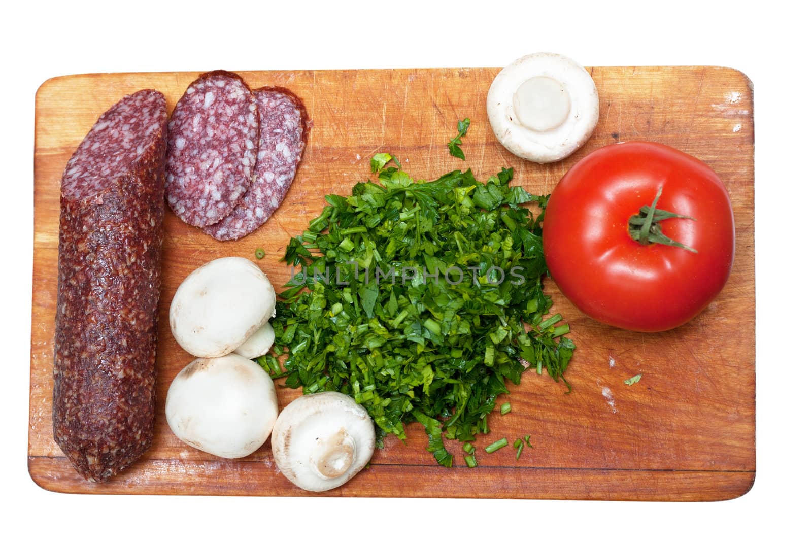 Some ingredients for pizza: parsley, sasuage, tomatoes.